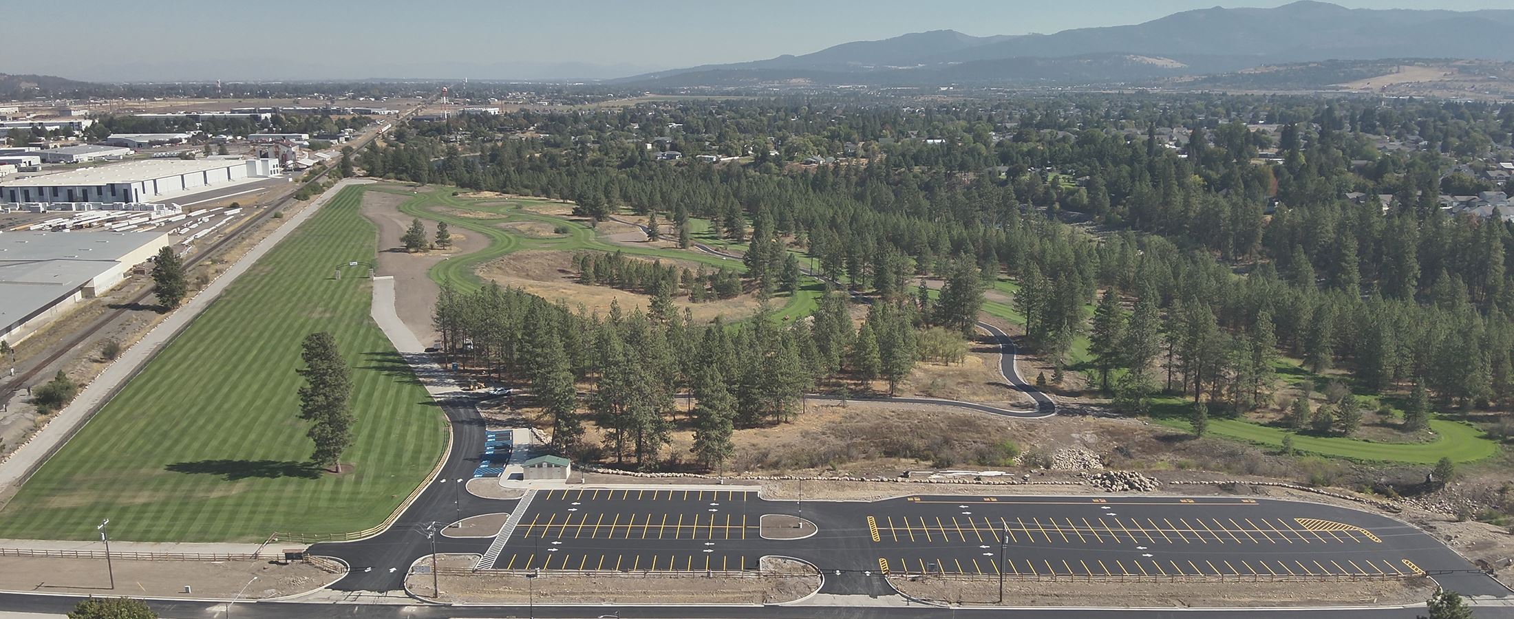 View from aerial drone of grass course and parking area.